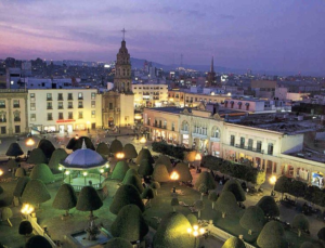 Imagen panorámica nocturna del centro histórico de León, donde a fondo se percibe parte de la zona residencial de esta zona